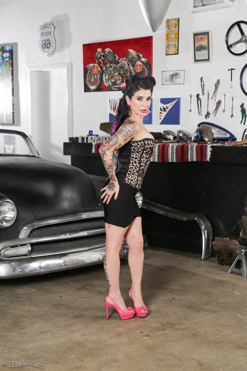 17P A estrela pornográfica Joanna Angel com tinta e penteado sexy à moda antiga posa em um carro velho
