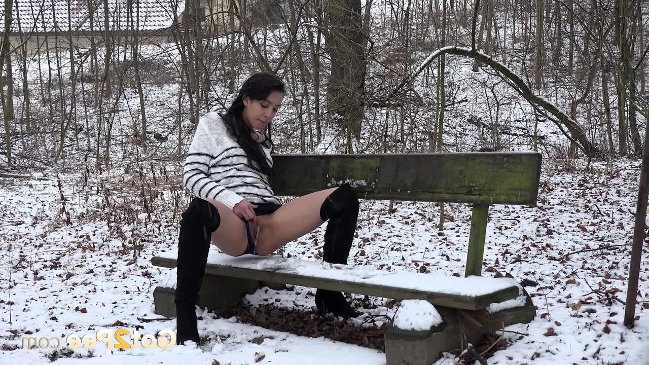 15P Dark-haired girl Esperansa pees on a snow-covered bench in over the knee boots