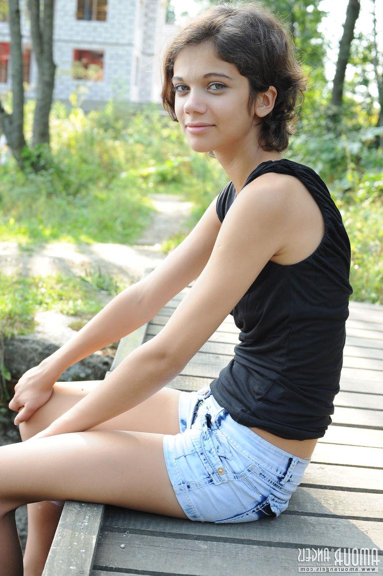 20P Pretty dark haired Tina removes her black dress by the pond to show tiny tits