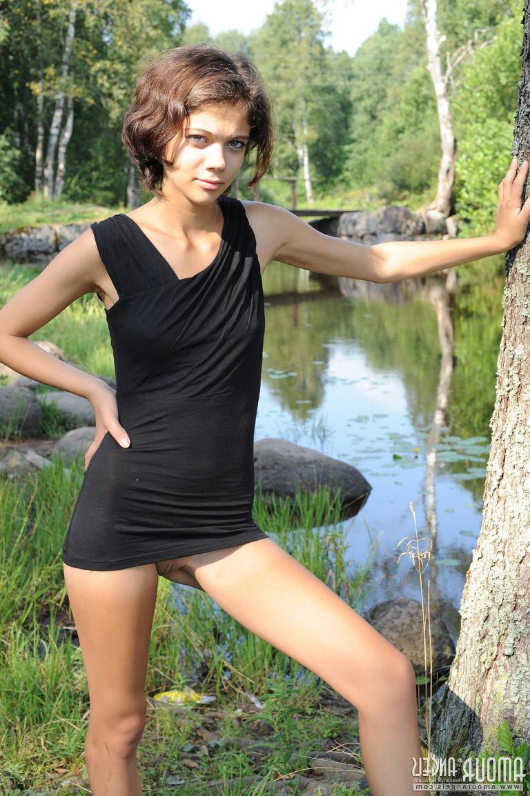 20P Pretty dark haired Tina removes her black dress by the pond to show tiny tits