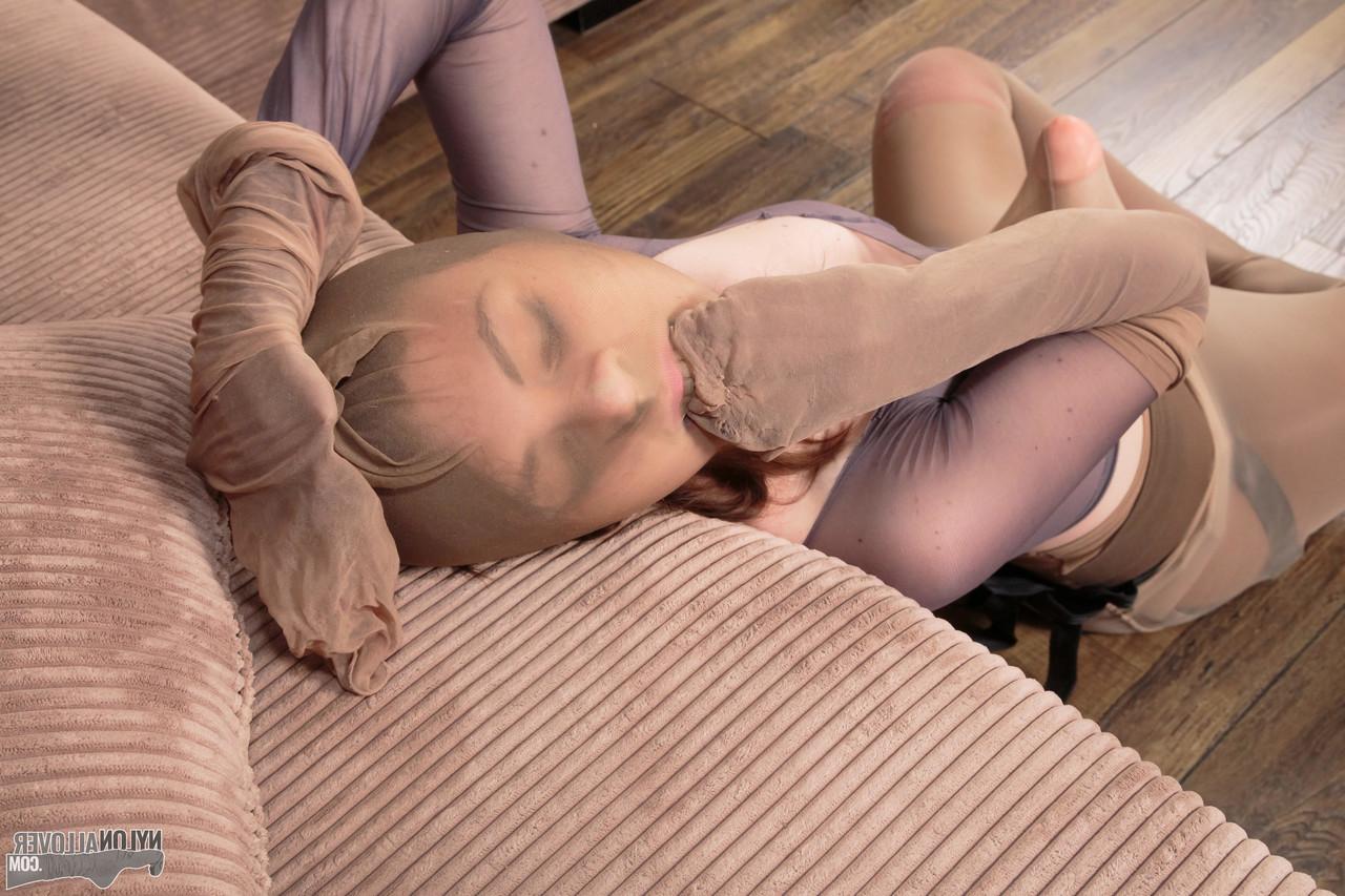 16P Pretty girl Mia adorns herself in layers of pantyhose and a strapon cock