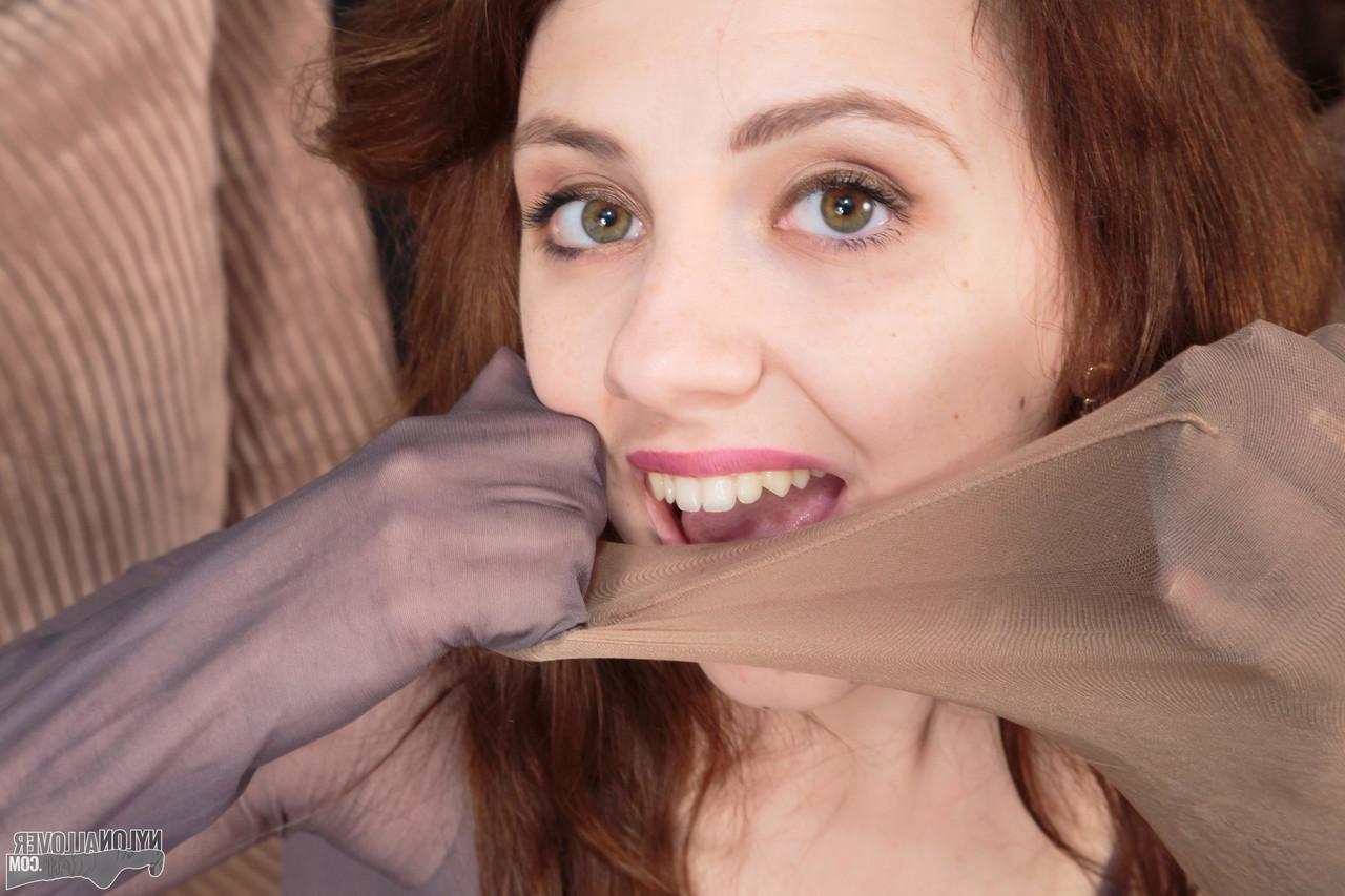 16P Pretty girl Mia adorns herself in layers of pantyhose and a strapon cock