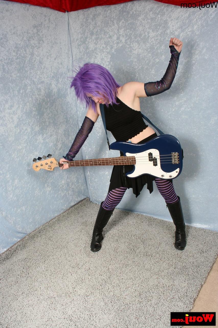 15P Purple-haired guitarist posing in her sexy black outfit in a solo