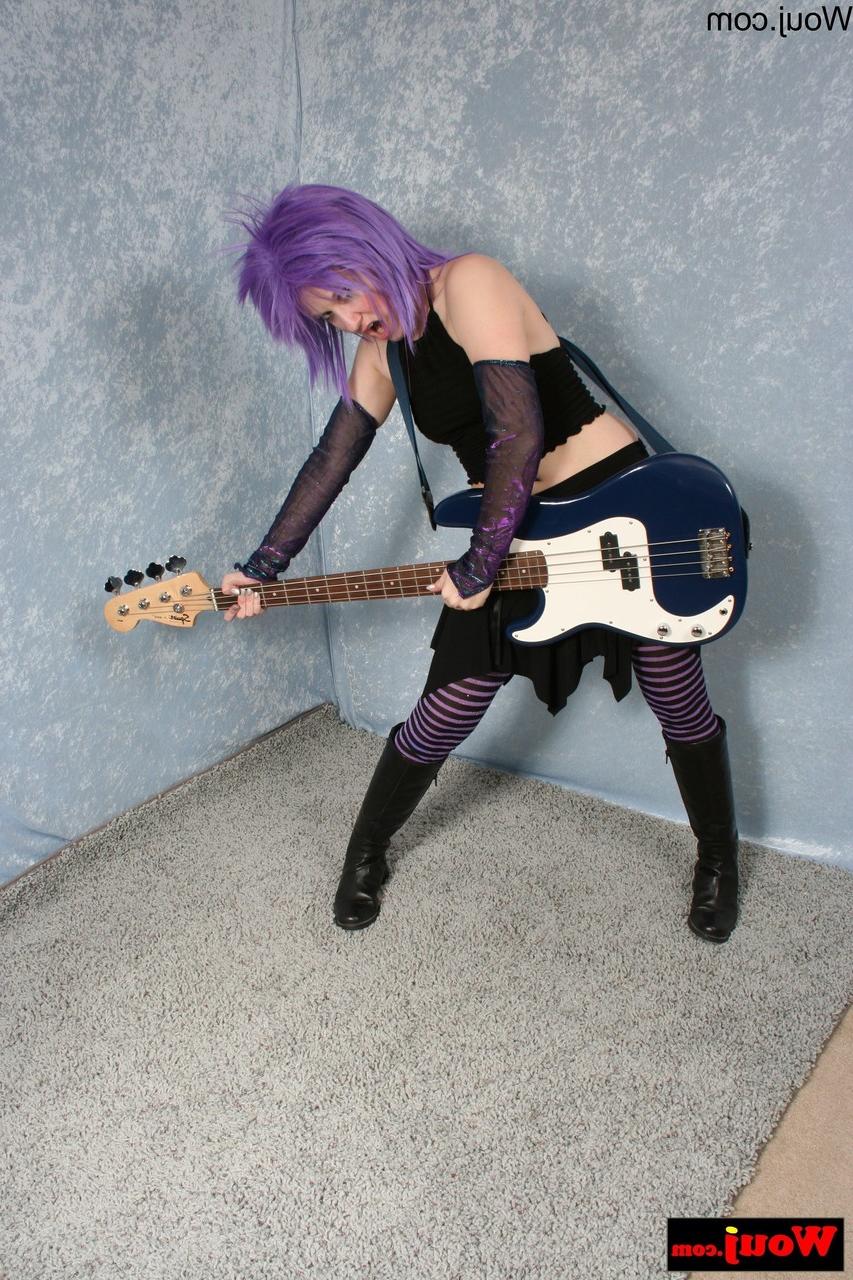 15P Purple-haired guitarist posing in her sexy black outfit in a solo
