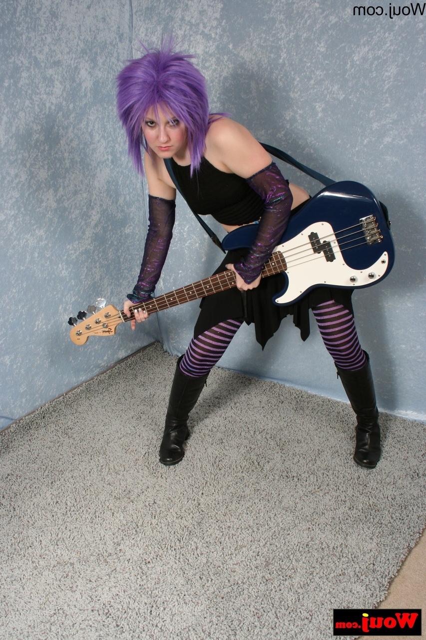 15P Purple-haired guitarist posing in her sexy black outfit in a solo
