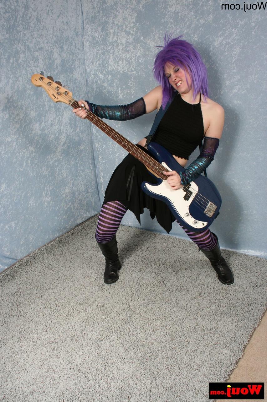 15P Purple-haired guitarist posing in her sexy black outfit in a solo