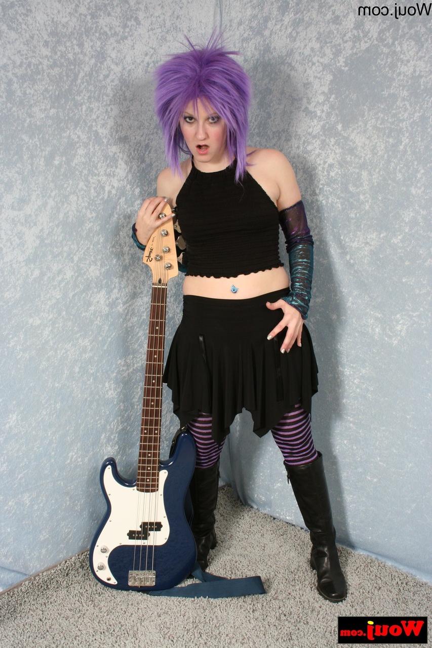 15P Purple-haired guitarist posing in her sexy black outfit in a solo