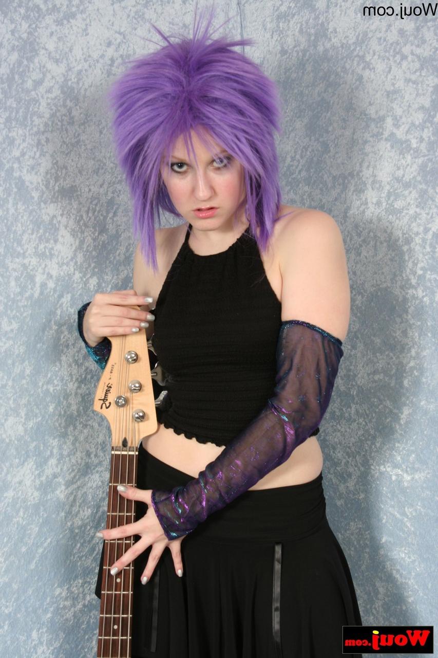 15P Purple-haired guitarist posing in her sexy black outfit in a solo
