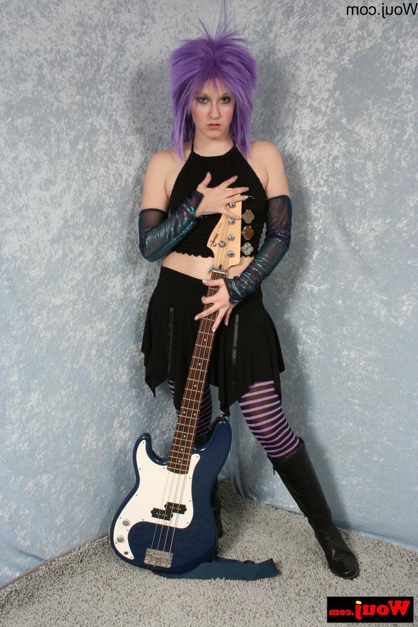 15P Purple-haired guitarist posing in her sexy black outfit in a solo
