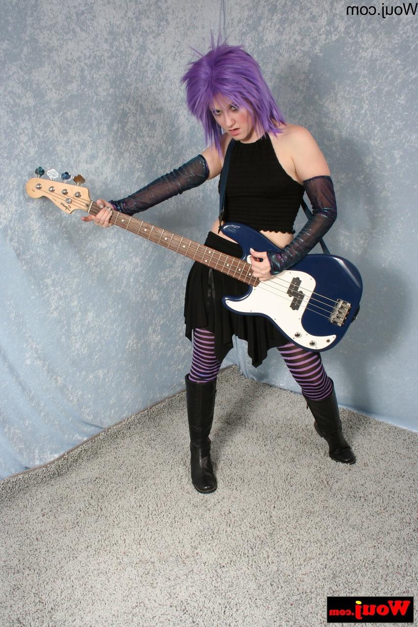15P Purple-haired guitarist posing in her sexy black outfit in a solo