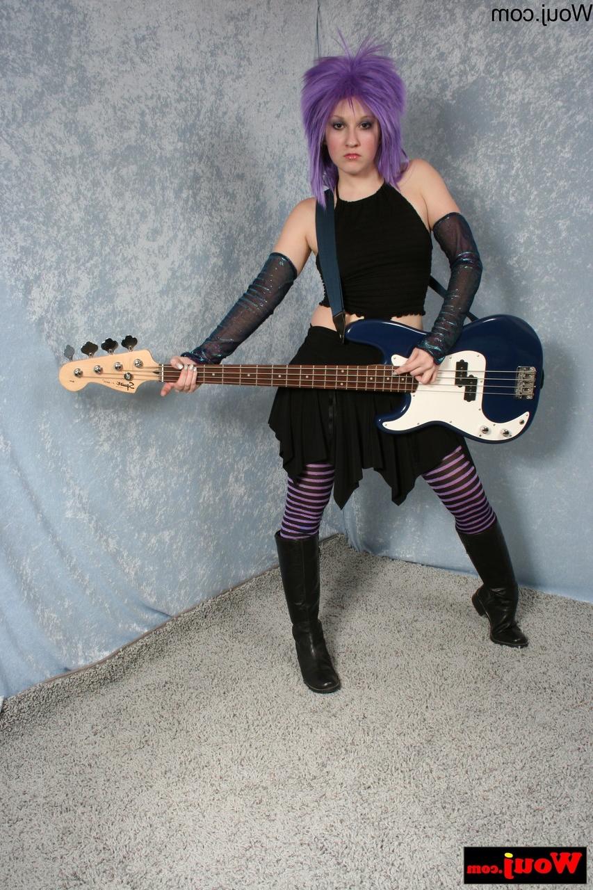 15P Purple-haired guitarist posing in her sexy black outfit in a solo