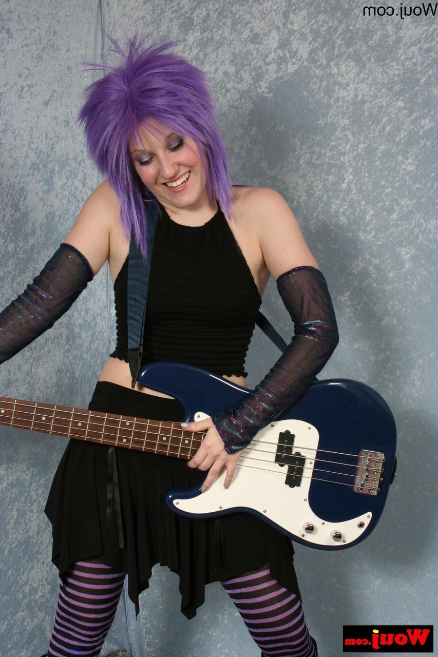 15P Purple-haired guitarist posing in her sexy black outfit in a solo