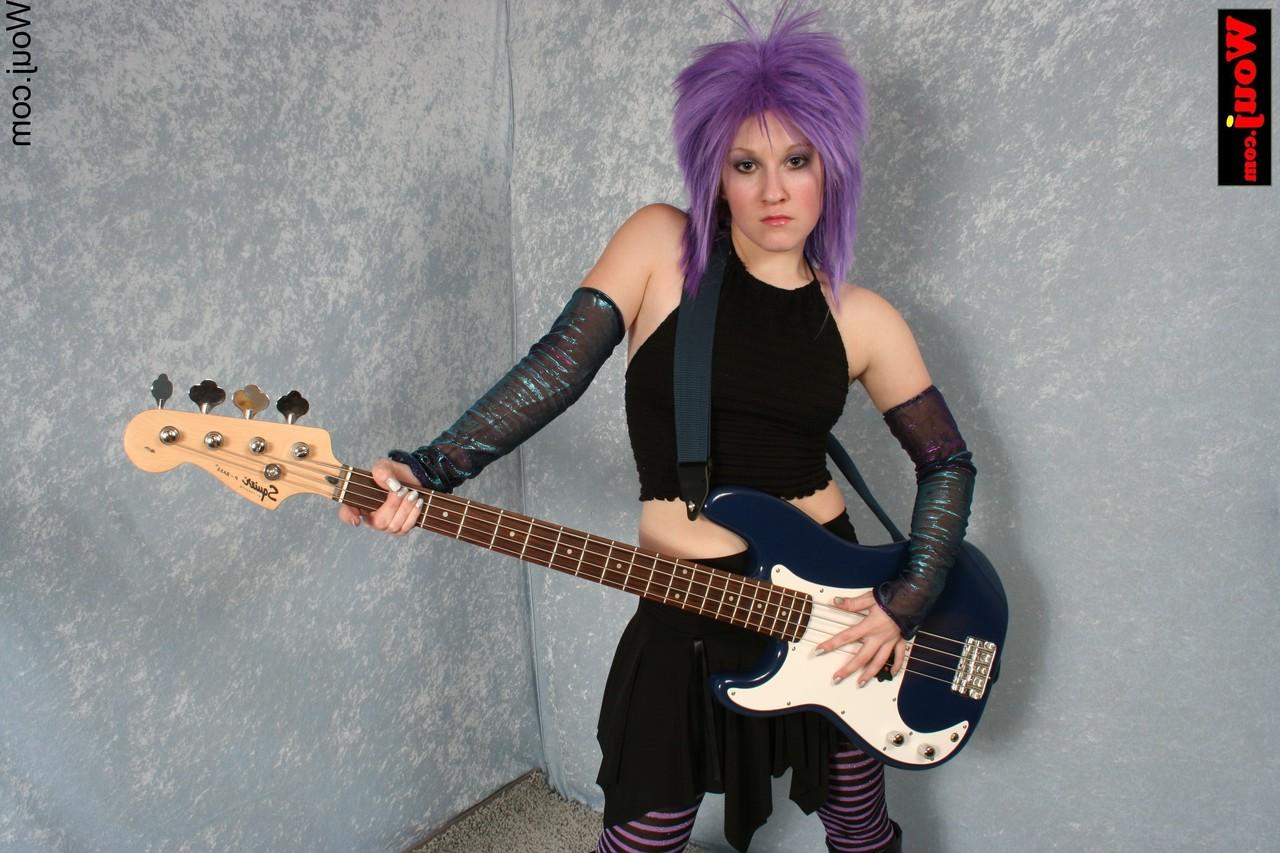 15P Purple-haired guitarist posing in her sexy black outfit in a solo