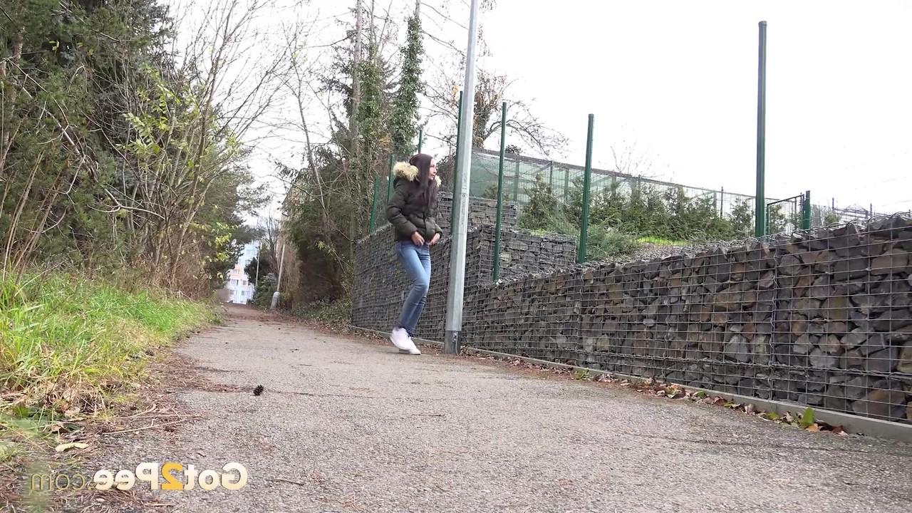 15P Brunette girl Mistika gets caught with her pants down while peeing on a road