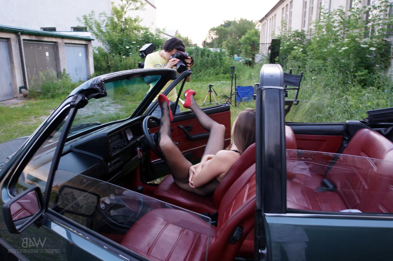 20P Glamorous Czech Connie Carter showing her big tits & ass in a convertible