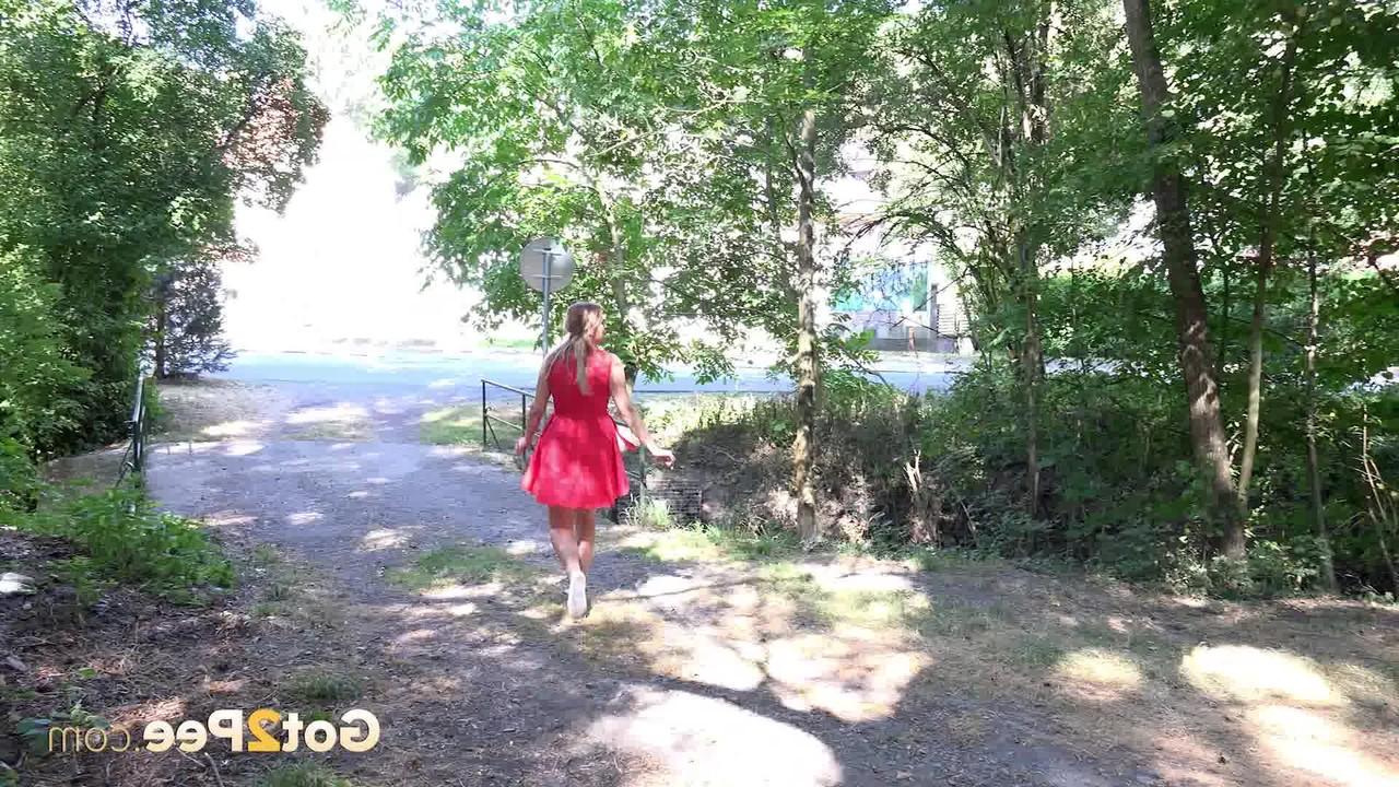 15P Nikki Dream takes a piss in a treed clearing while wearing no panties