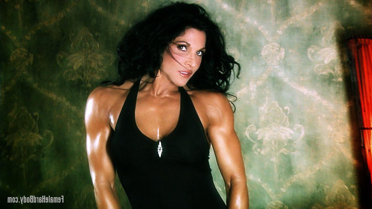 20P Brunette bodybuilder Tracy Daniels displays her tanned body in a sexy dress