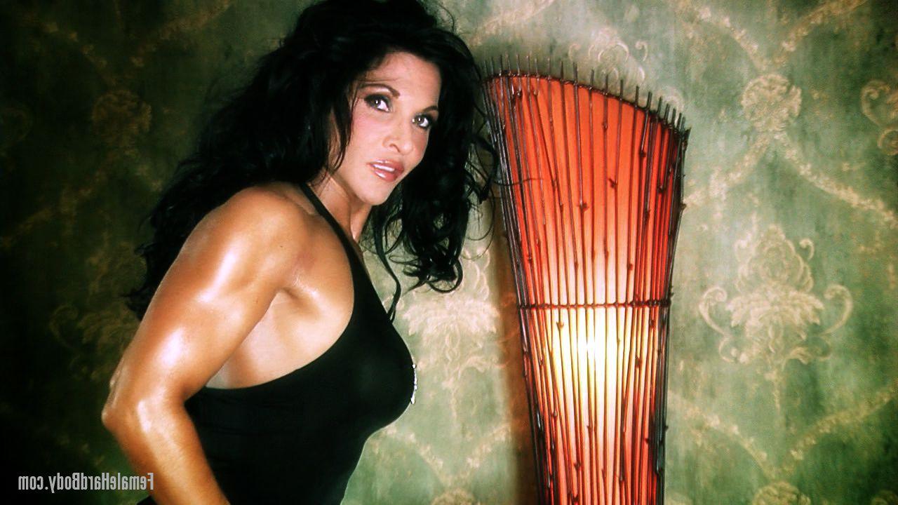 20P Brunette bodybuilder Tracy Daniels displays her tanned body in a sexy dress