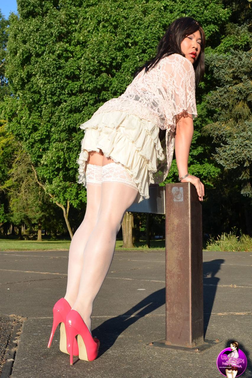 16P Slutty Asian shemale poses in a provocative outfit & high heels in public