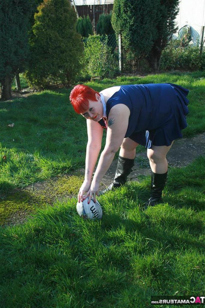 20P Fat redhead Valgasmic Exposed exposes her tits while playing with a football