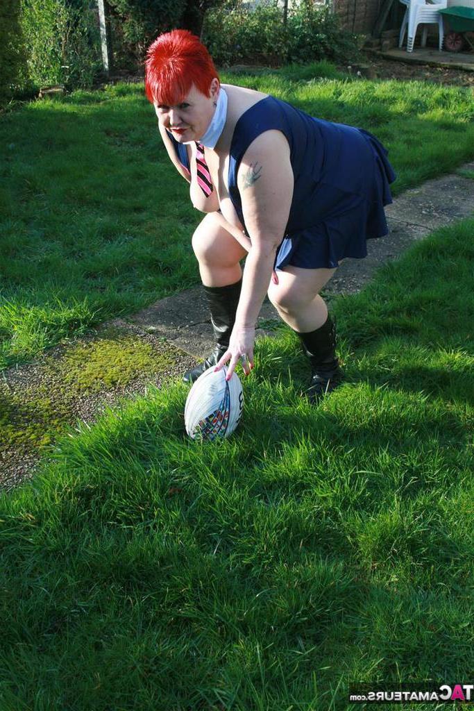 20P Fat redhead Valgasmic Exposed exposes her tits while playing with a football