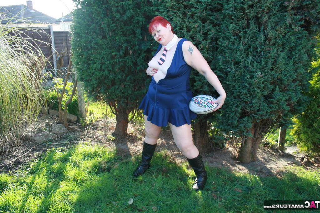 20P Fat redhead Valgasmic Exposed exposes her tits while playing with a football