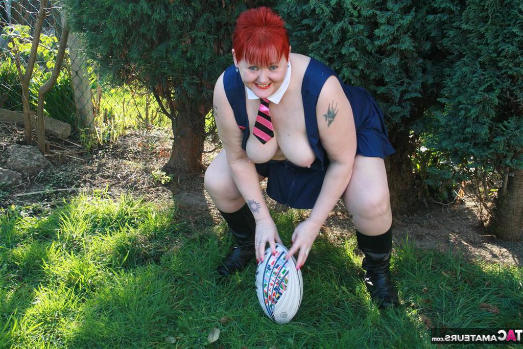 20P Fat redhead Valgasmic Exposed exposes her tits while playing with a football