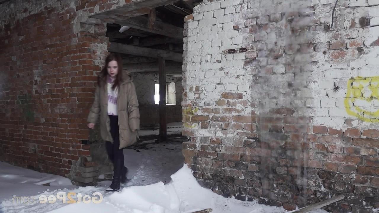 15P Katya Red takes a pee on snow-covered ground in an abandoned building
