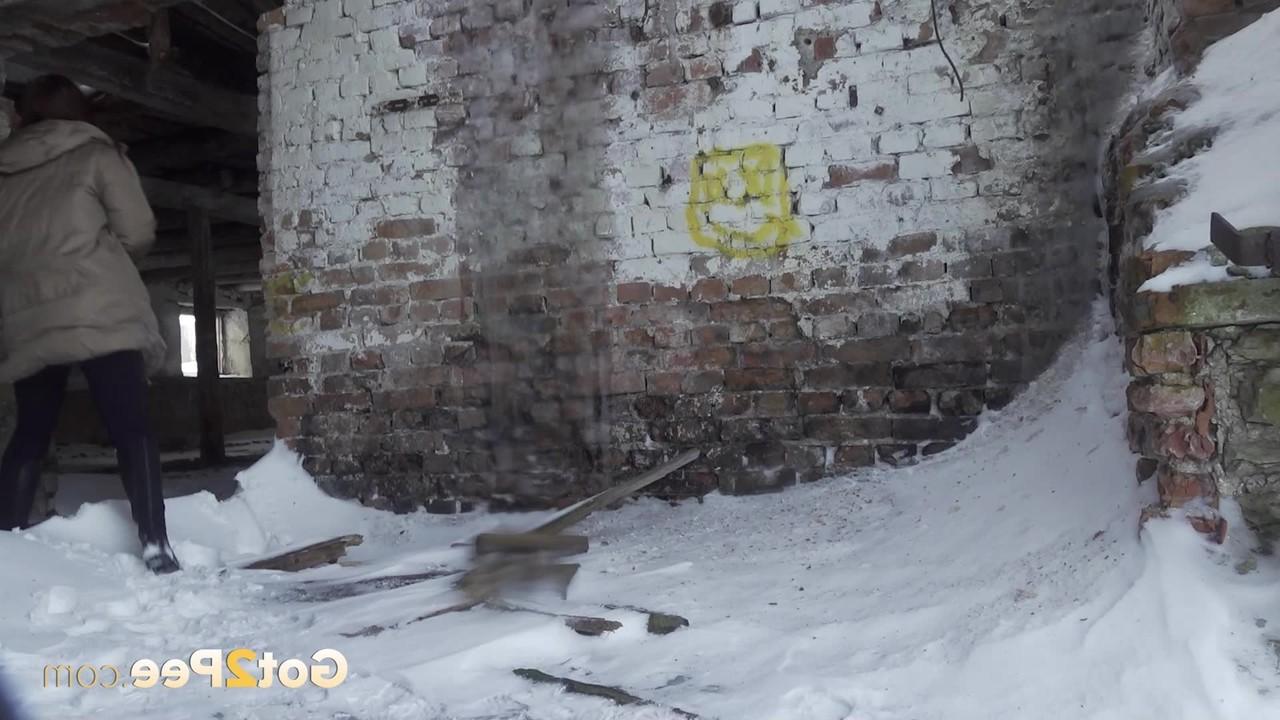 15P Katya Red takes a pee on snow-covered ground in an abandoned building