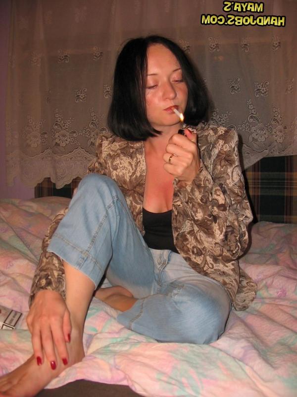 14P Raven-haired babe Maya strips and touches herself while smoking a cigarette