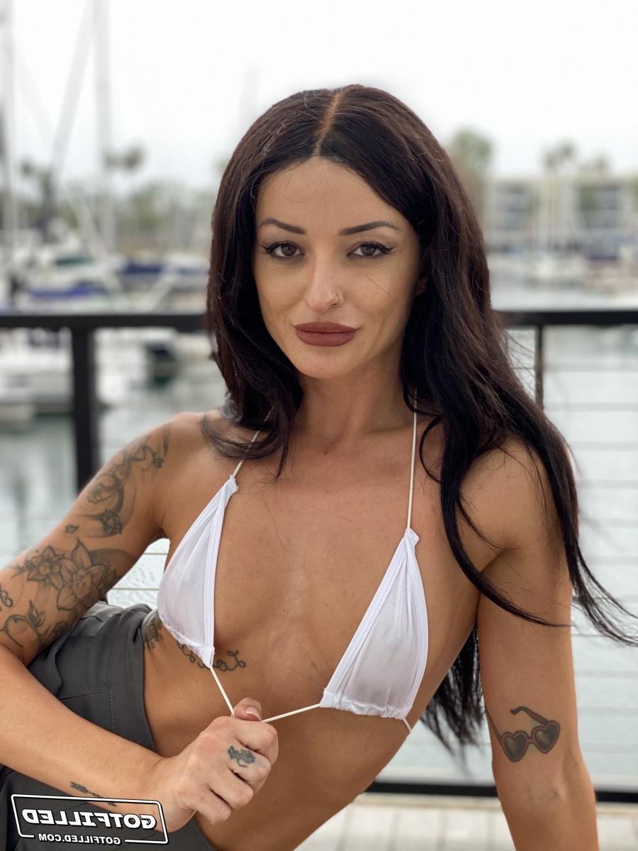 20P Tattooed brunette Charlie Valentine models a bikini at a marina before POV sex