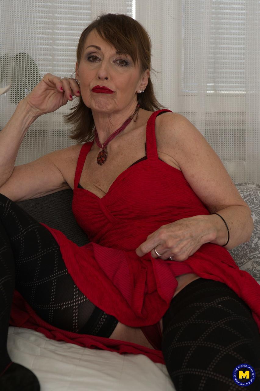 17P Mature lady Danny poses in her dress, stockings & panties & touches herself