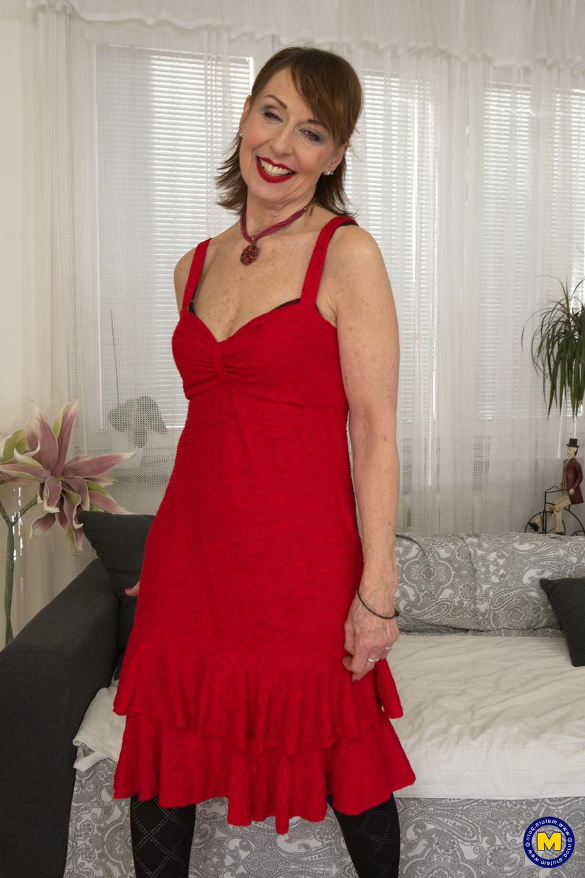 17P Mature lady Danny poses in her dress, stockings & panties & touches herself