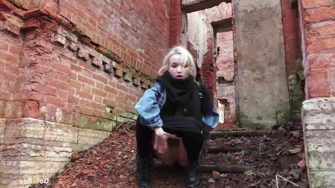 15P Pretty blonde Masha pulls down her tights for a piss by an abandoned building