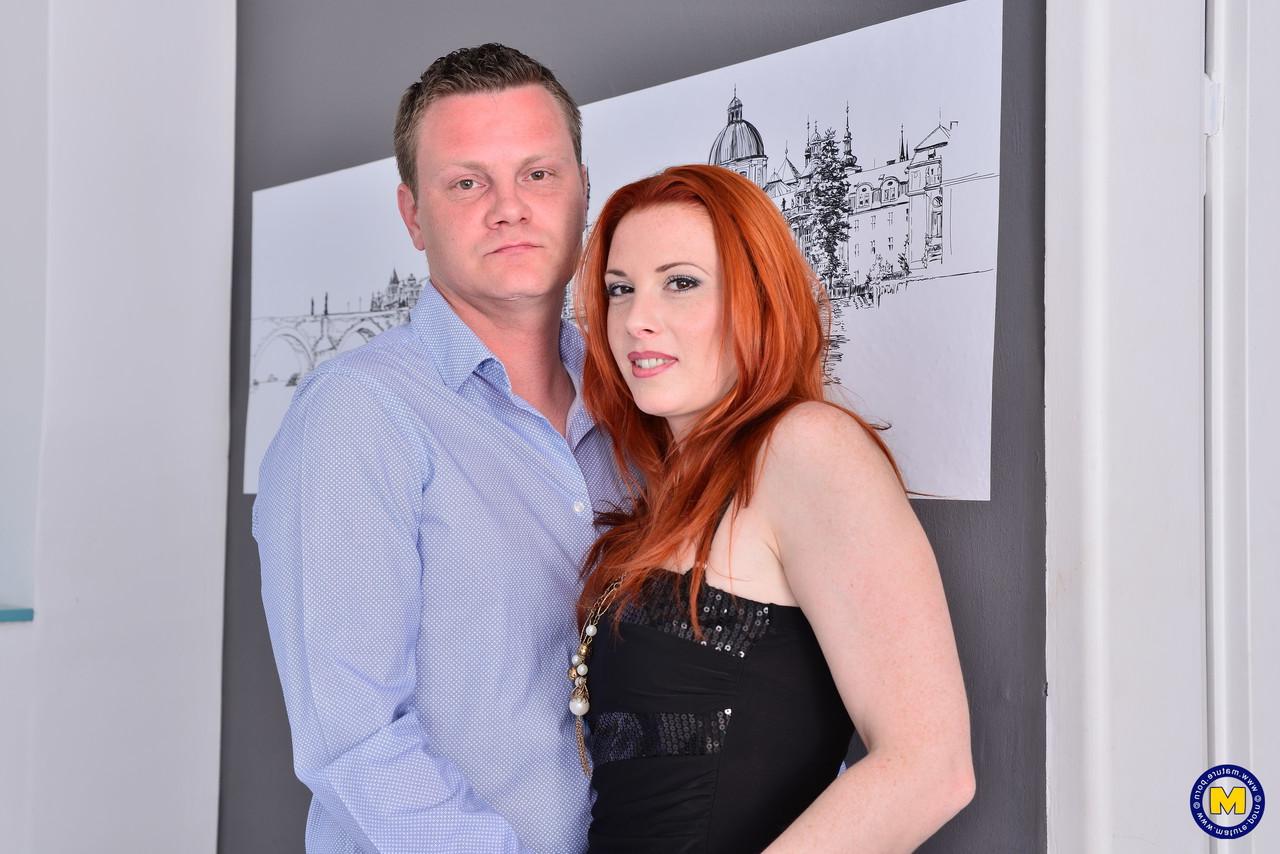 16P Natural redhead Michelle Russo is freed from a black dress before sex on a bed