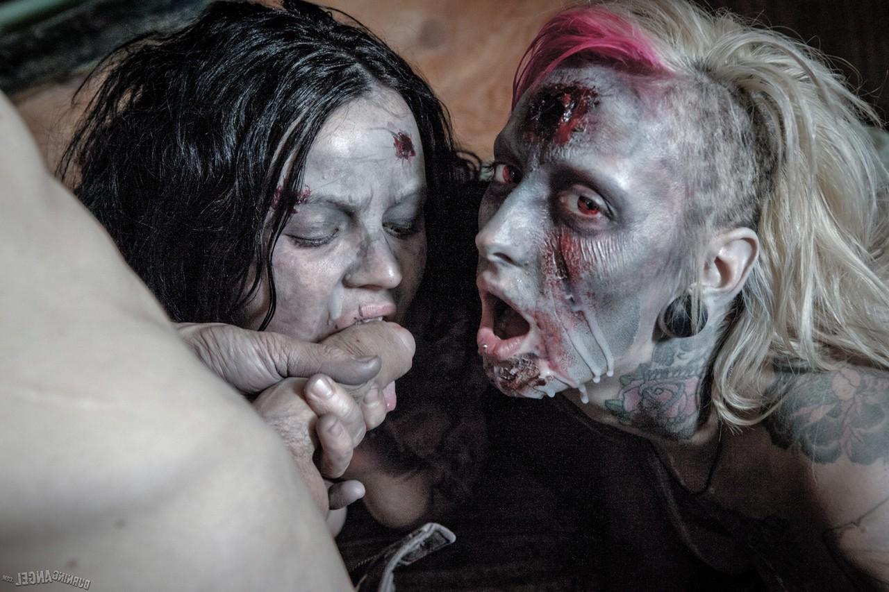14P Fetish models Brittany Lynn and Jessie Lee giving head in Zombie threesome