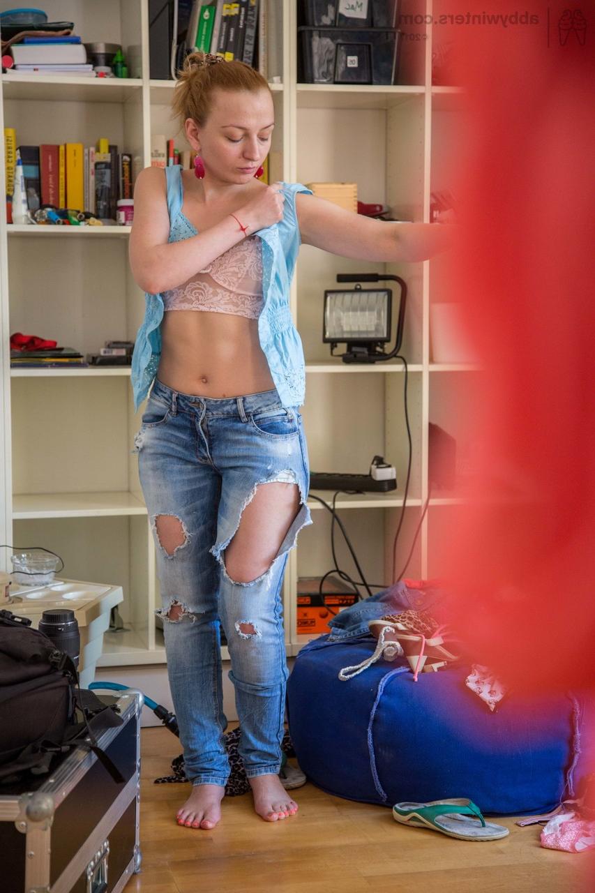 17P Naked redhead pulls on a ripped pair of blue jeans over top of her pretties