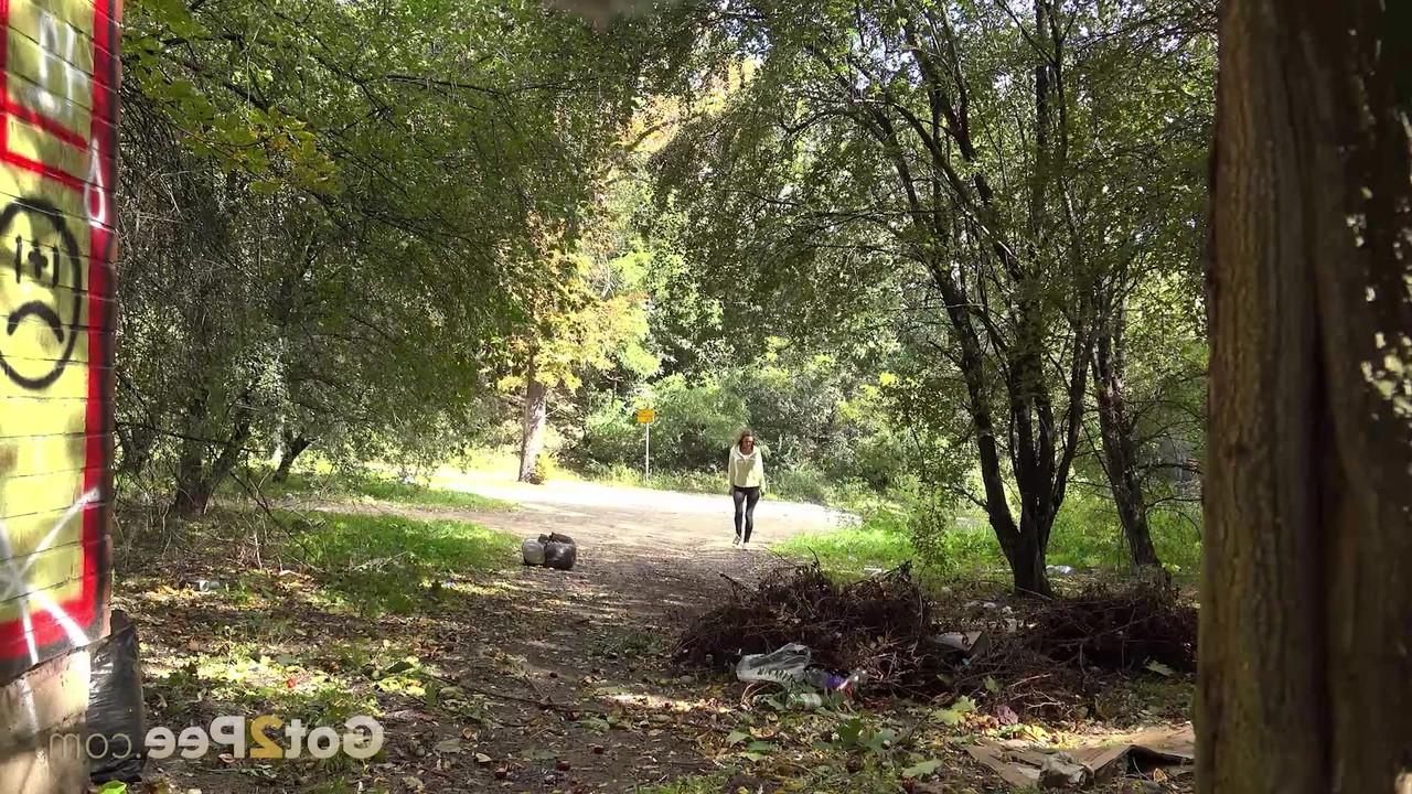 15P Cynthia Vellons pulls down her black pants to pee off the side of a road