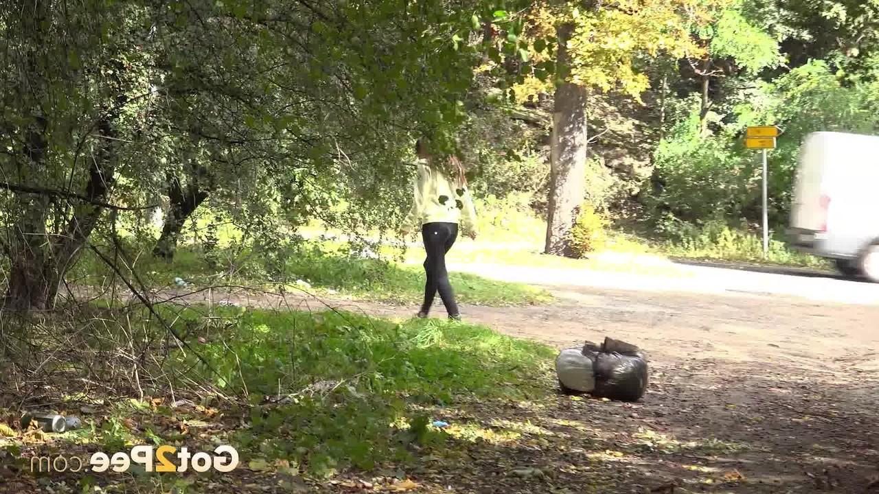 15P Cynthia Vellons pulls down her black pants to pee off the side of a road