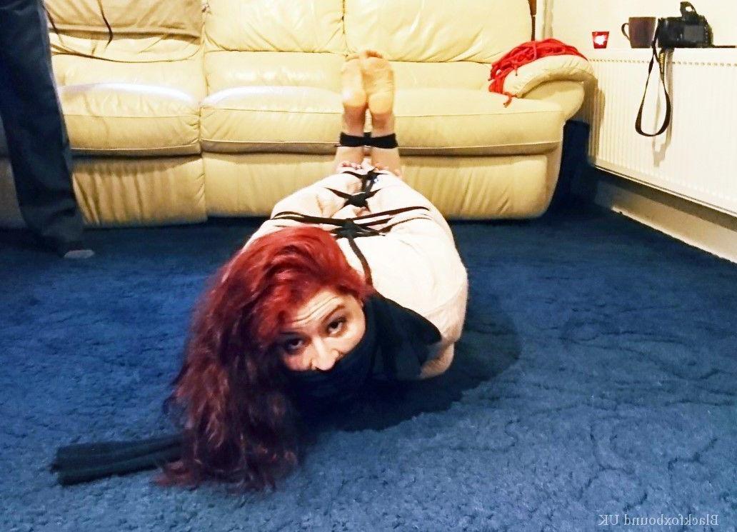 16P Redheaded female is silenced with a gag while tightly bound