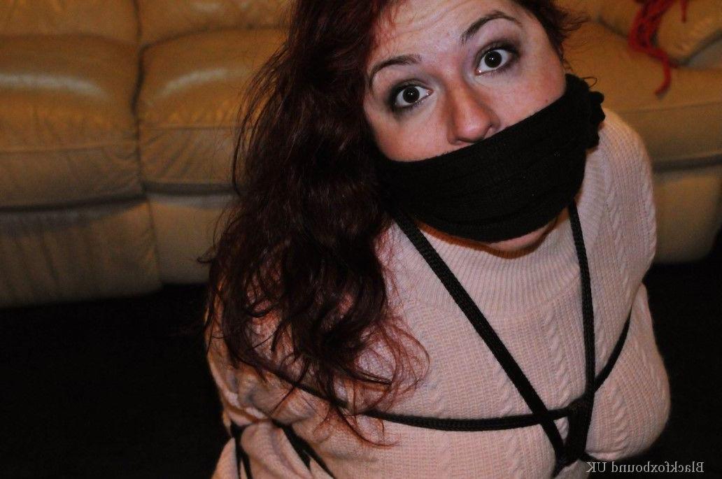 16P Redheaded female is silenced with a gag while tightly bound