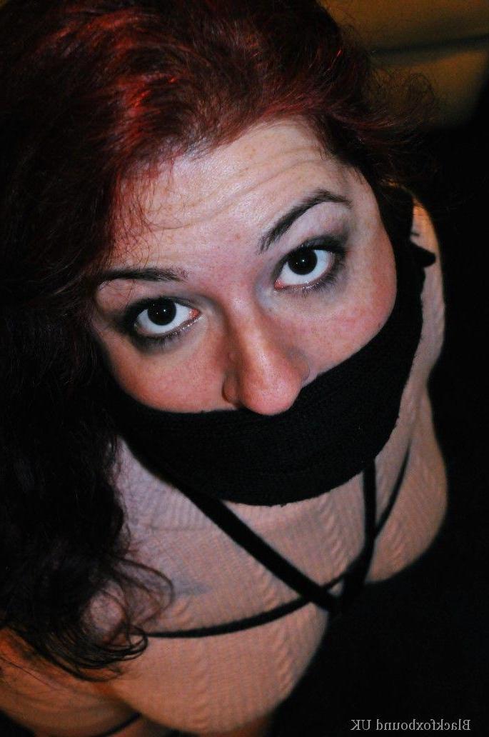 16P Redheaded female is silenced with a gag while tightly bound