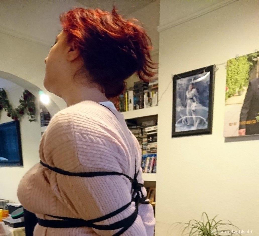 16P Redheaded female is silenced with a gag while tightly bound