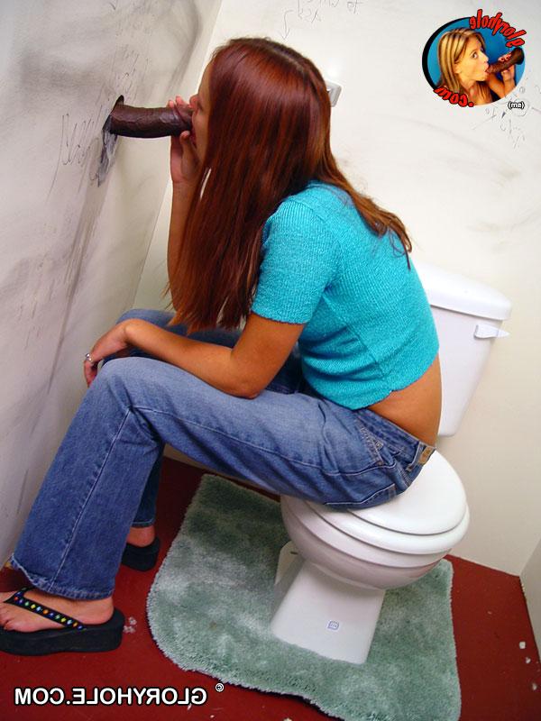 20P Redhead slut Saphire enjoys sucking a big black cock through a gloryhole