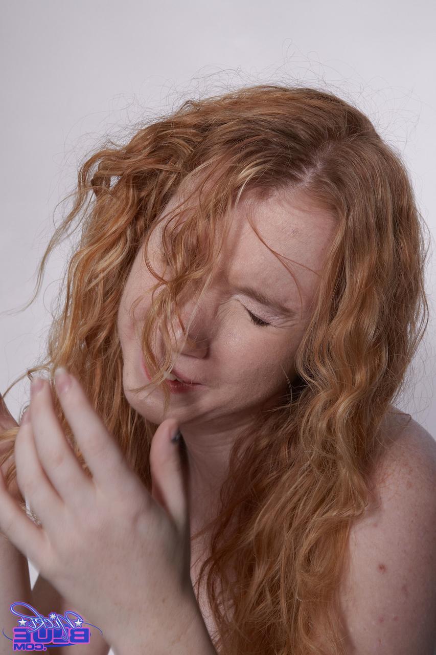 20P Petite curly haired redhead Nicki Blue flaunts her bush on a fitness ball