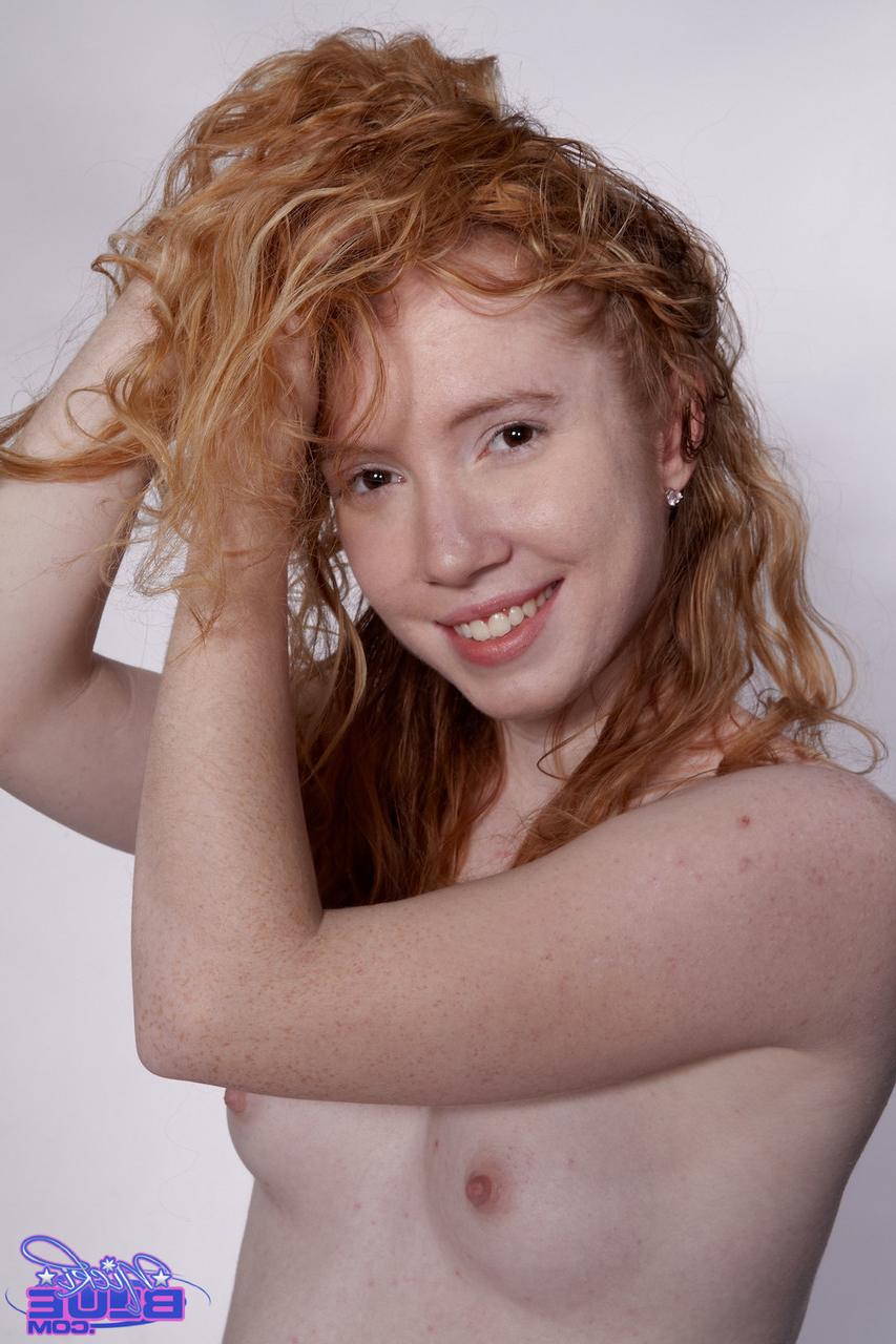 20P Petite curly haired redhead Nicki Blue flaunts her bush on a fitness ball