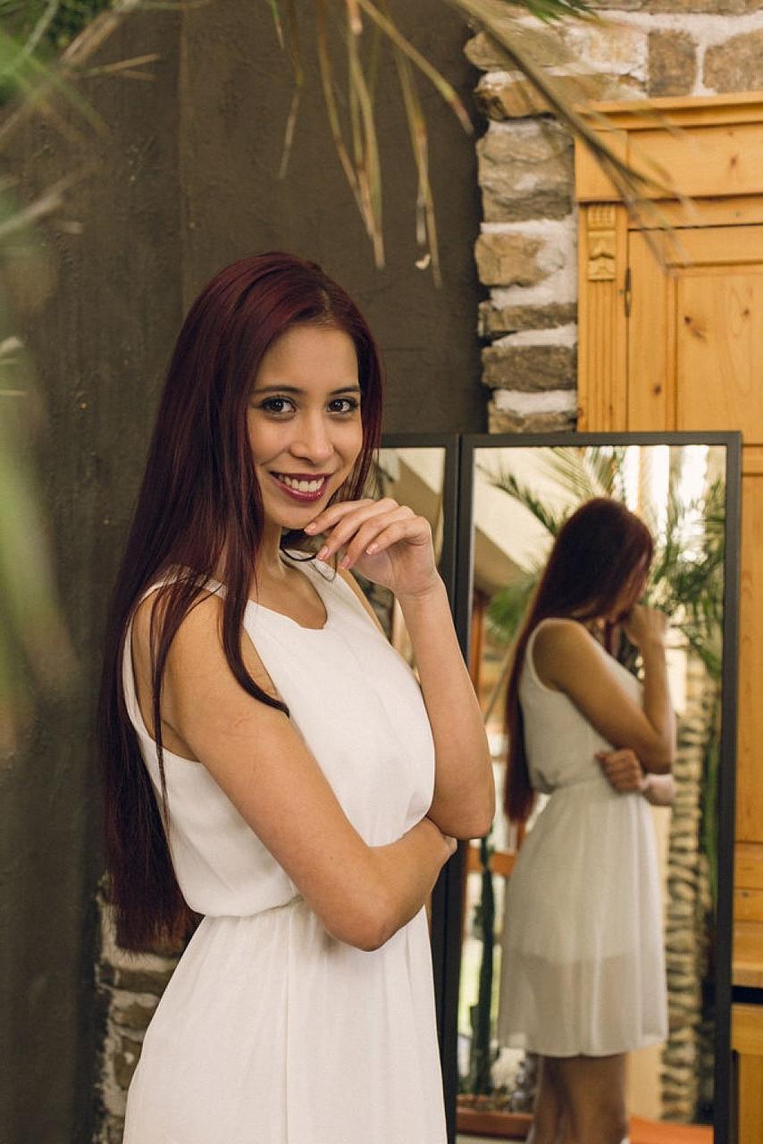 14P Long-haired teen Paula Shy looks in a mirror before a nude finger fuck