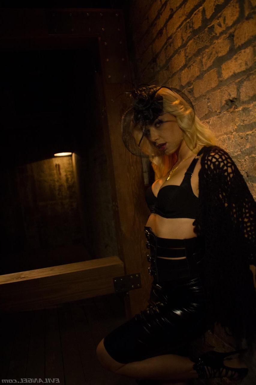 17P Blonde vampire exposes her fangs and boobs in a poorly lit cellar