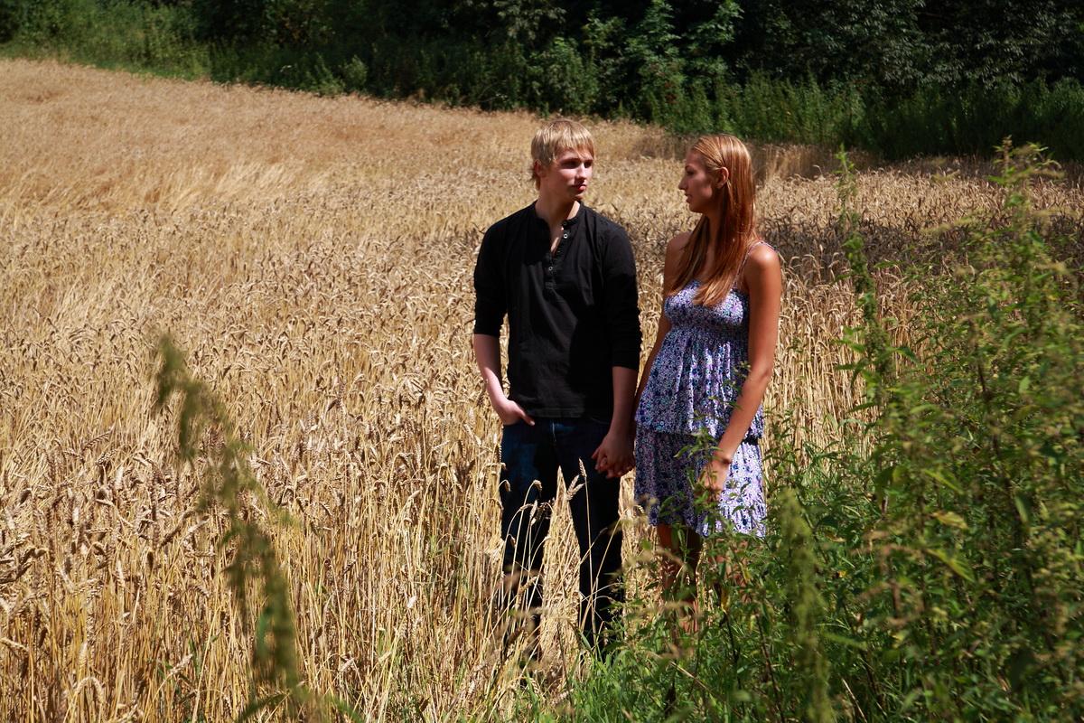 10P Young couple have sexual intercourse in a field of mature wheat