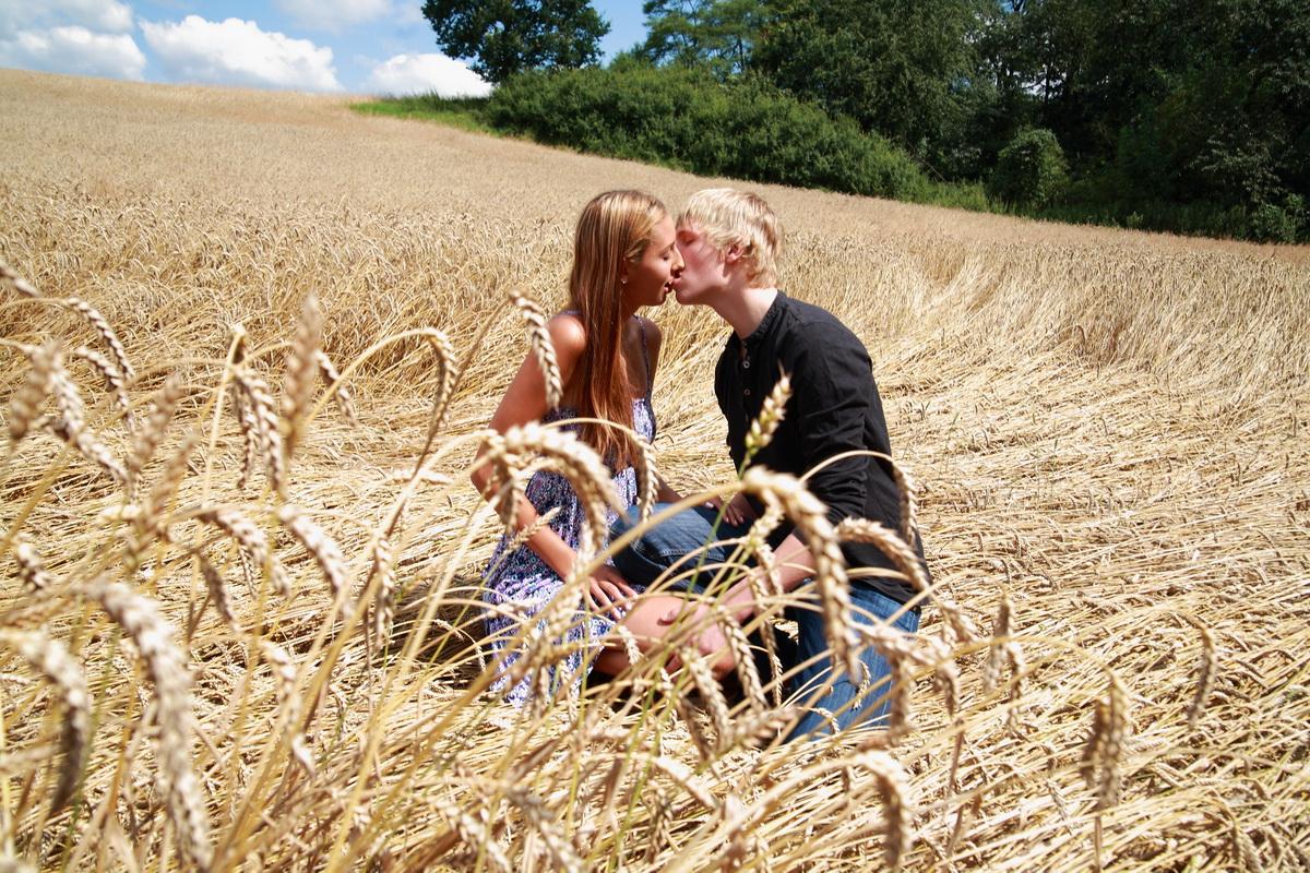 10P Young couple have sexual intercourse in a field of mature wheat